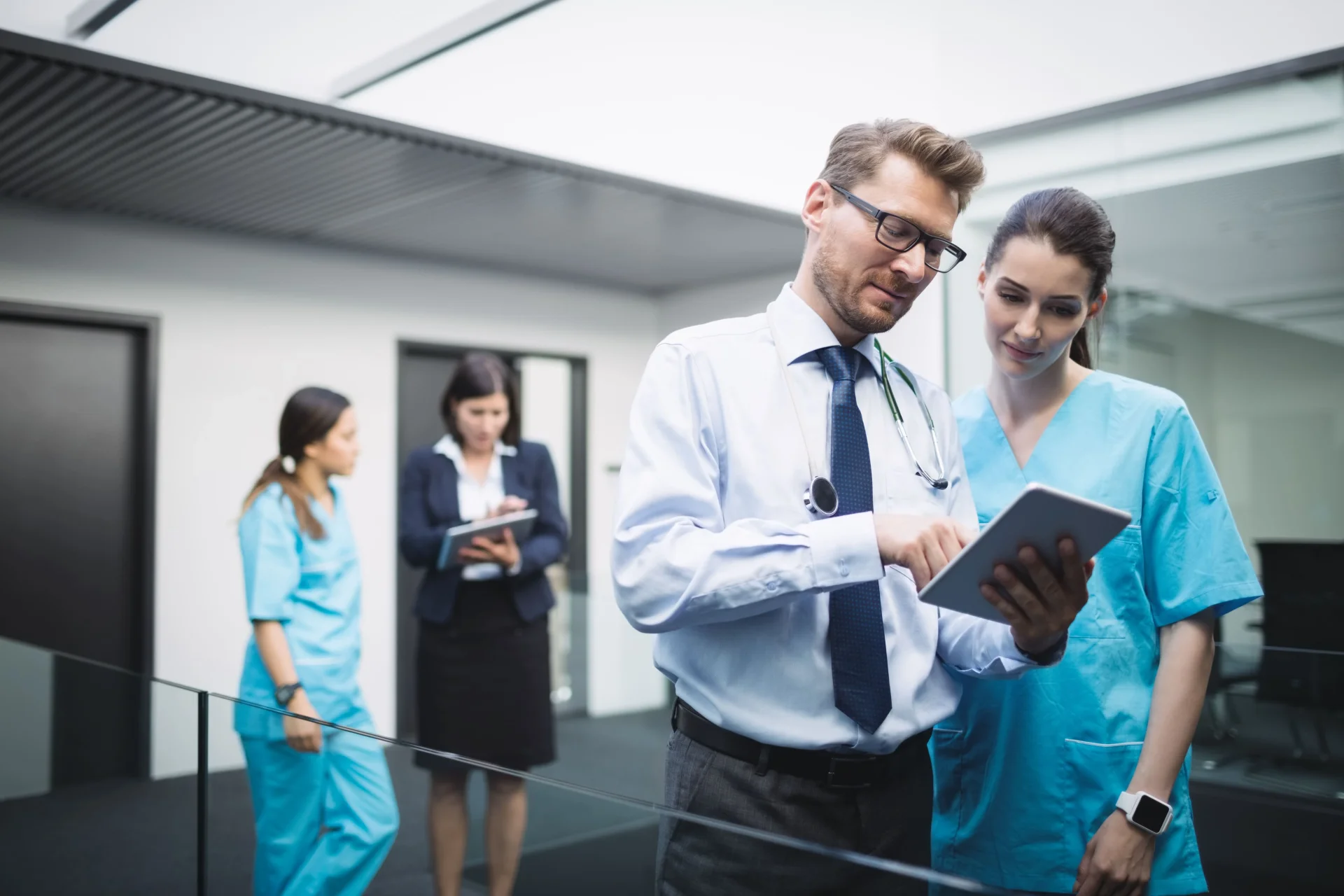 doctor-nurse-discussing-digital-tablet doctor-nurse-discussing-digital-tablet