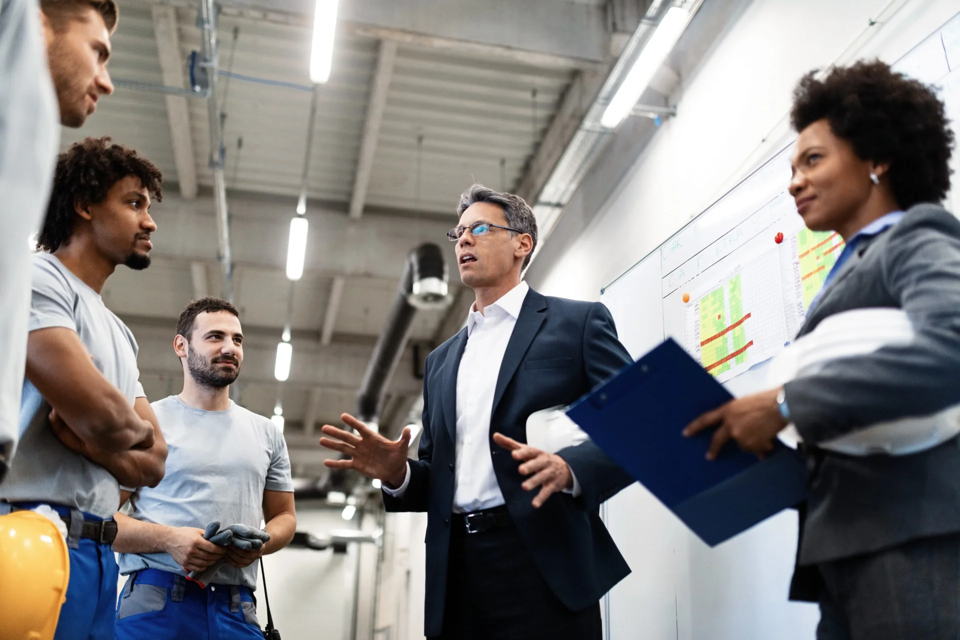 factory-manager-holding-meeting-talking-his-employees factory-manager-holding-meeting-talking-his-employees