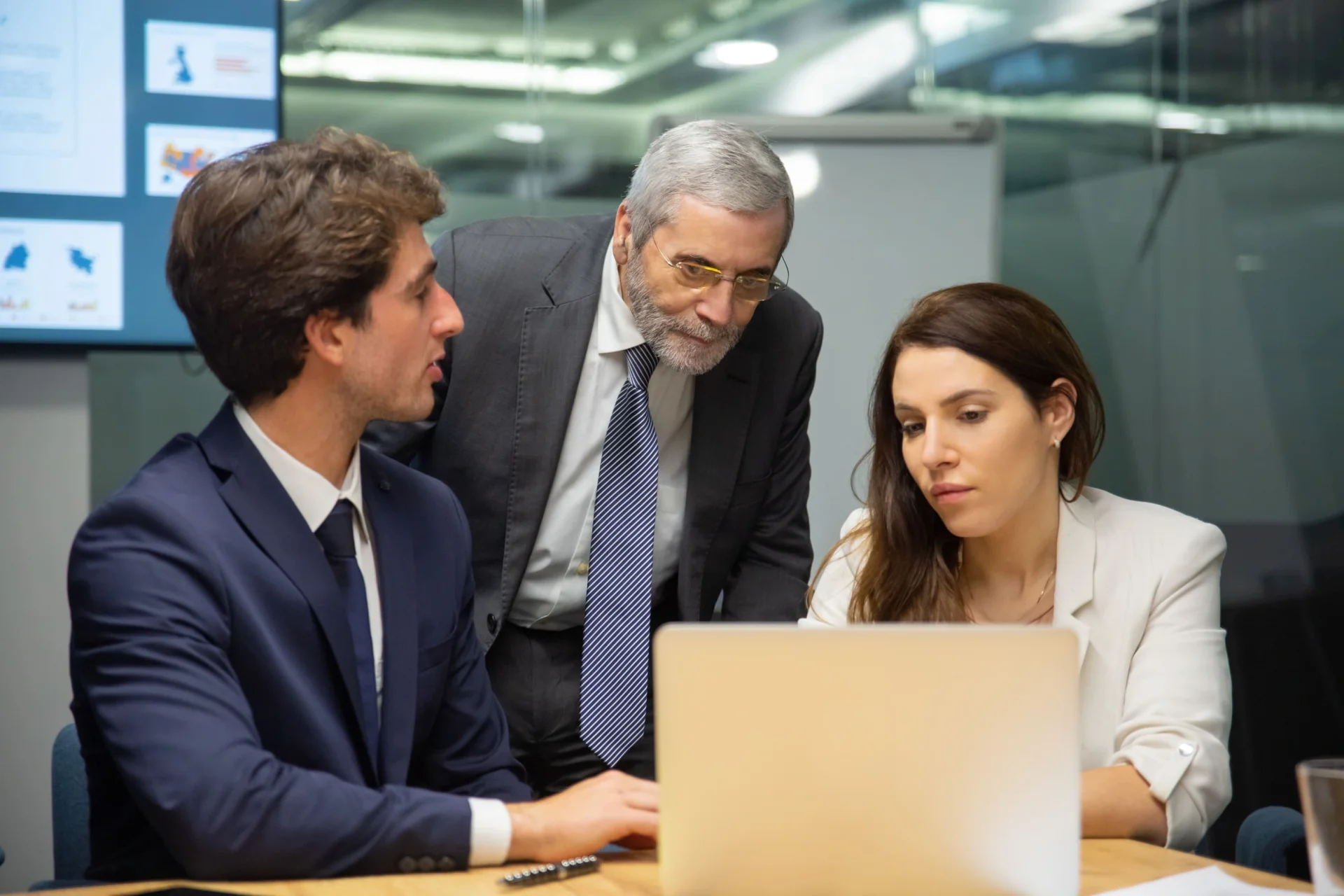 front-view-confident-business-team-looking-laptop front-view-confident-business-team-looking-laptop