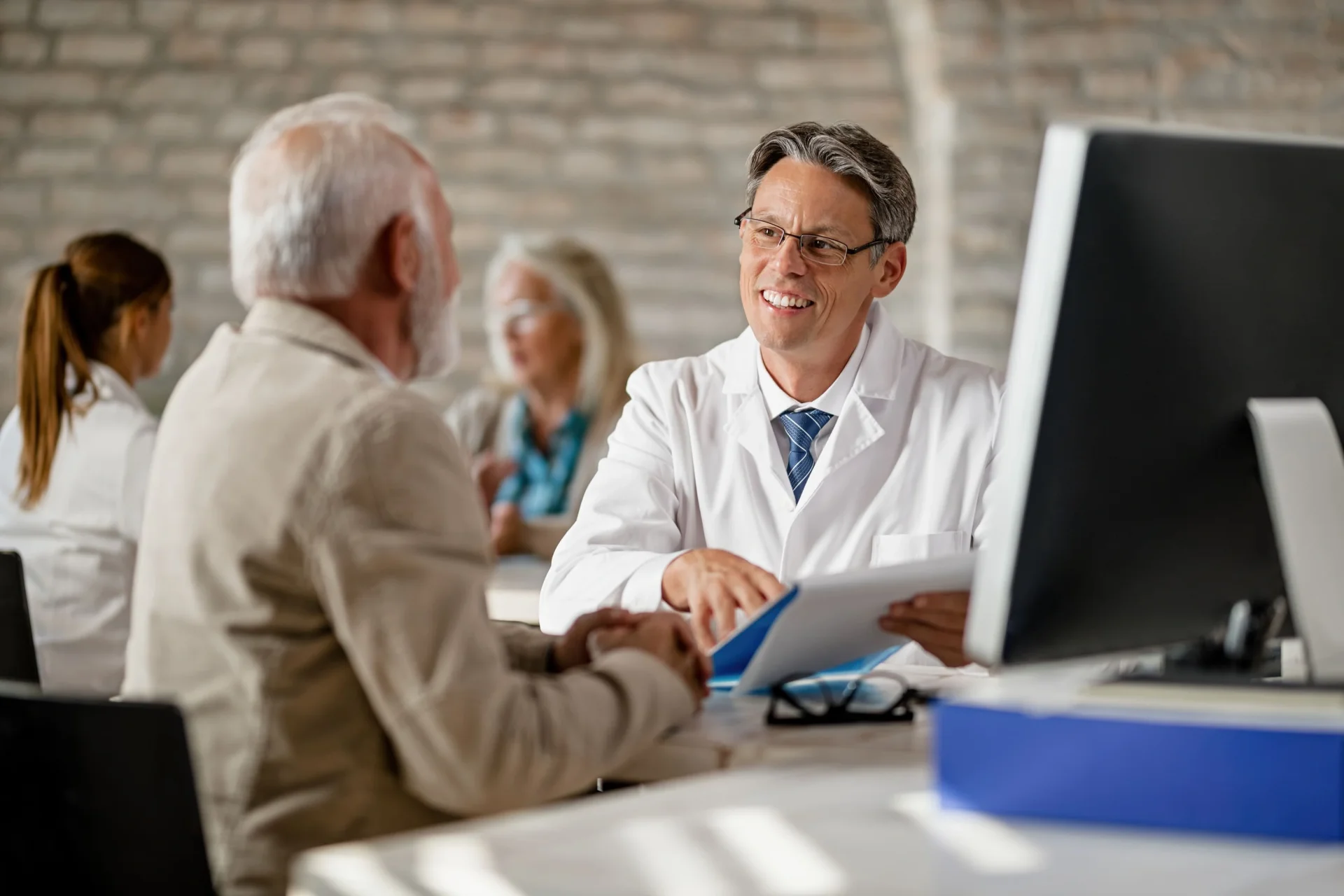 happy-male-doctor-explaining-medical-record happy-male-doctor-explaining-medical-record