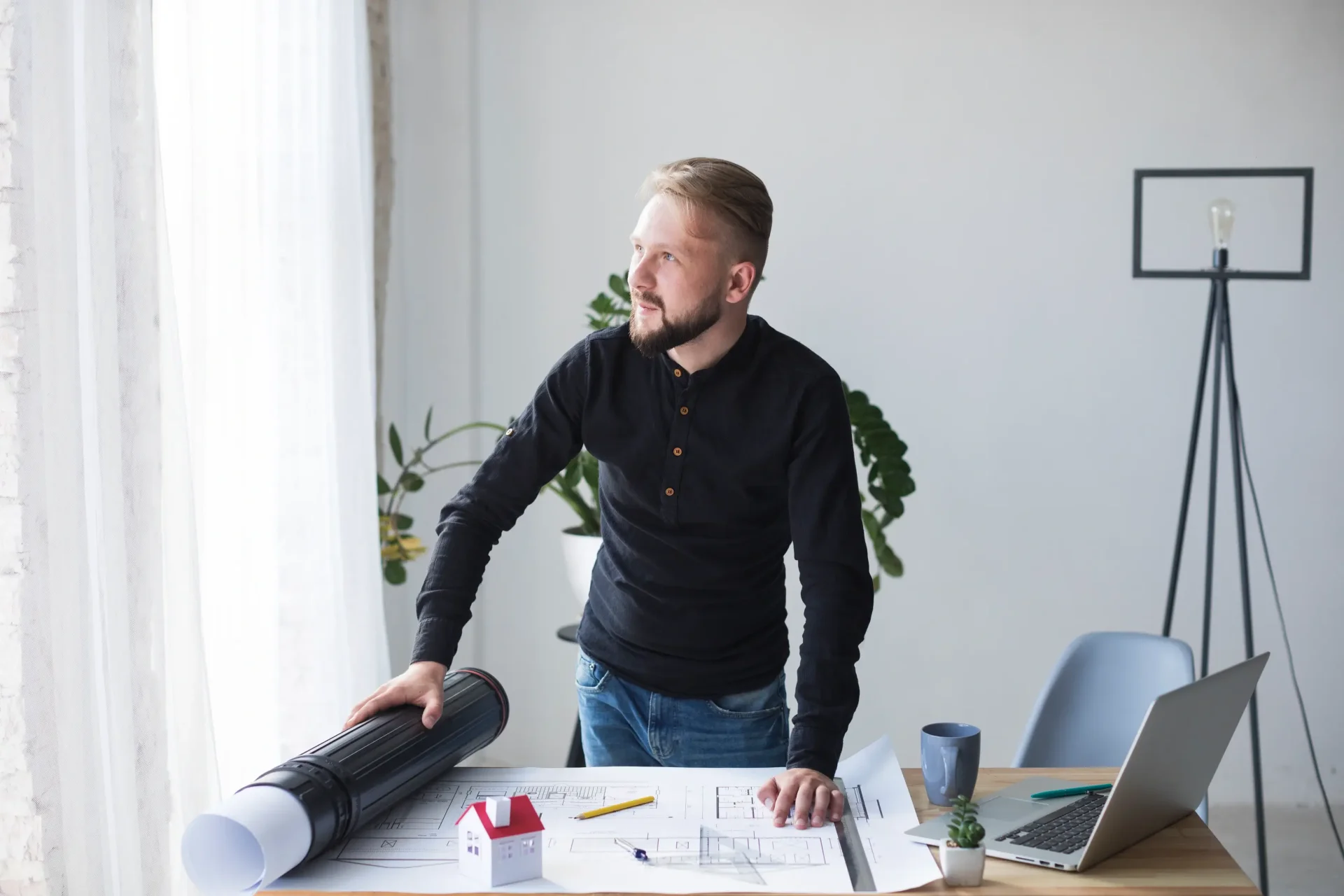 young-male-architect-his-office-looking-away young-male-architect-his-office-looking-away