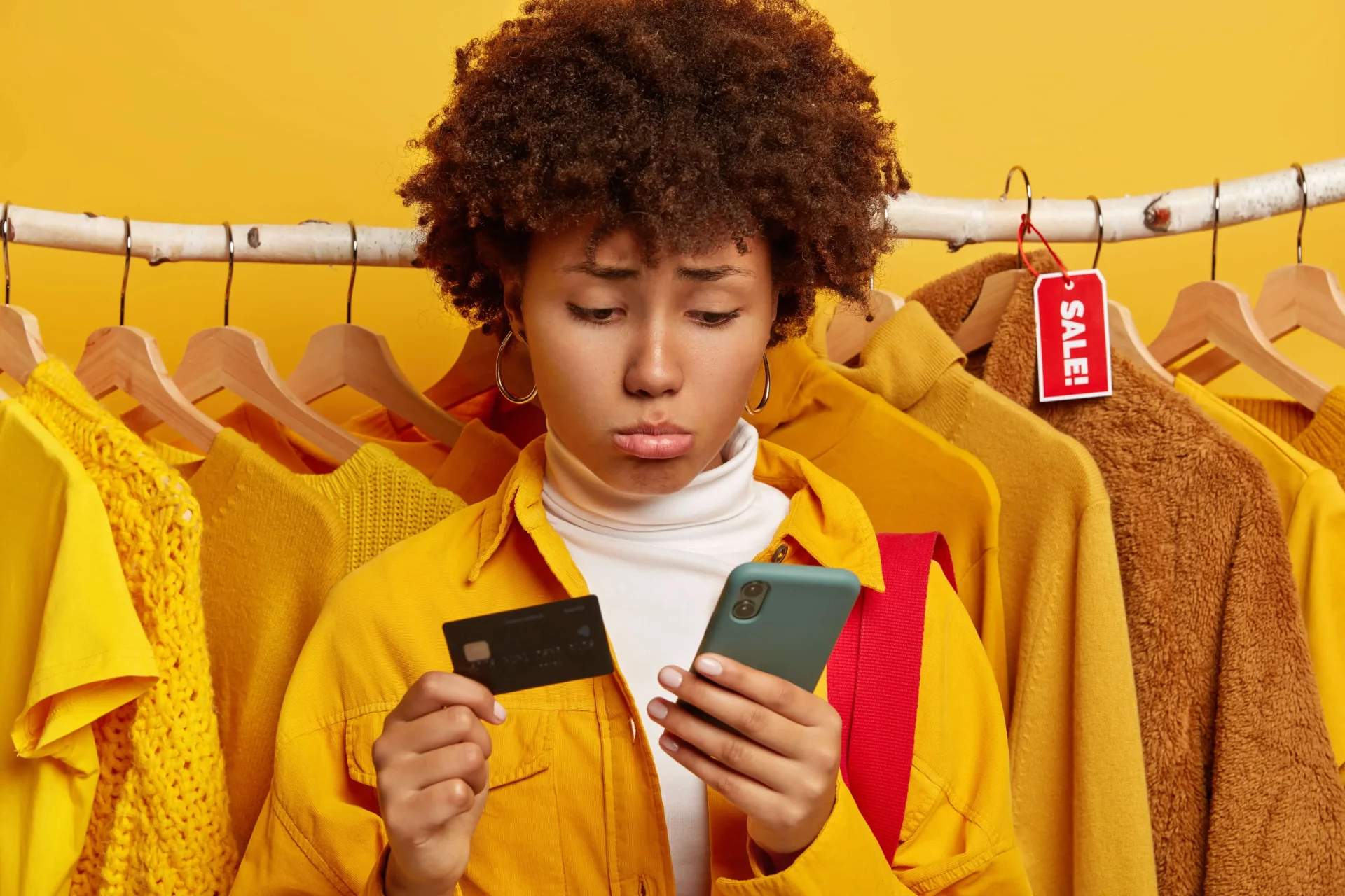 unhappy-curly-woman-uses-credit-card unhappy-curly-woman-uses-credit-card